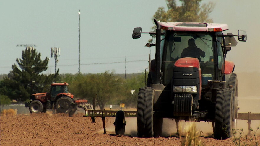 Tractors tend a cotton farm in Marana on April 22, 2020. 