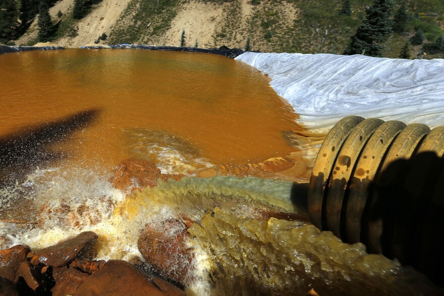 FILE - In this Aug. 14, 2015, photo, water flows through a series of sediment retention ponds built to reduce heavy metal and chemical contaminants from the Gold King Mine outside Silverton, Colo. New Mexico and the U.S. government have reached a $32 million settlement over a 2015 mine spill that polluted rivers in three western states. The spill of wastewater from the inactive Gold King Mine in southwestern Colorado, sending a bright-yellow plume of arsenic, lead and other heavy metals south to New Mexico, through the Navajo Nation and into Utah through the San Juan and Animas rivers. (AP Photo/Brennan Linsley, File)