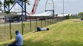 Workers taking a break from their jobs at a fish processing company in New Bedford have a view of the offshore wind terminal, June 7, 2023.