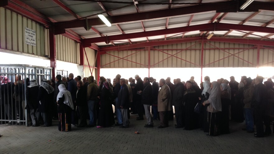 Palestinians line up at the Qalandia checkpoint between Ramallah and Jerusalem on a recent morning. Since Israel stopped requiring older Palestinians to obtain permits in advance, crowds have been growing, particularly on Friday when Muslims want to pray at Al-Aqsa Mosque in Jerusalem.