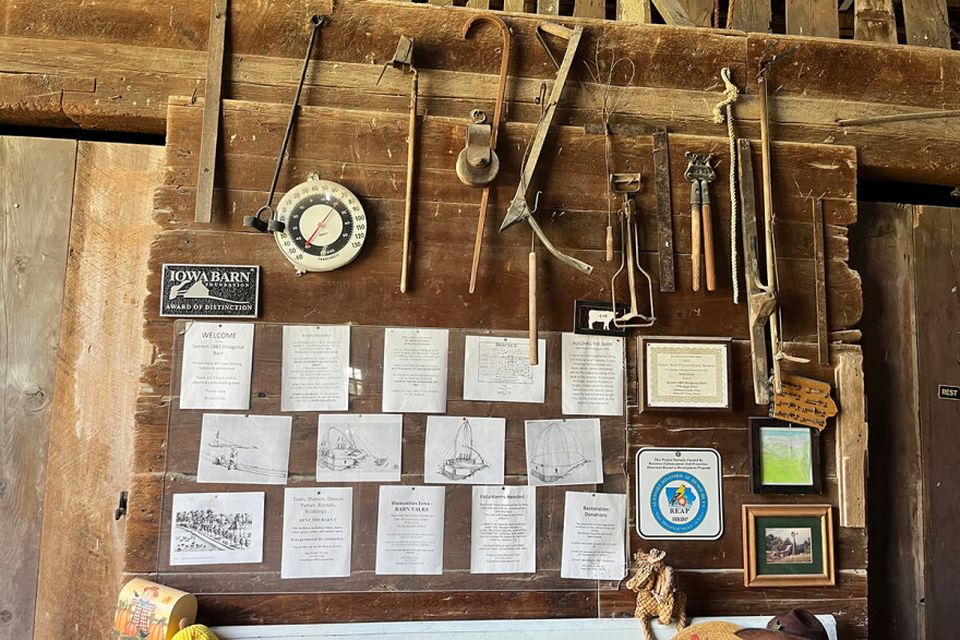 Documents with information about the barn's construction and farm tools are displayed inside the entrance to the barn.