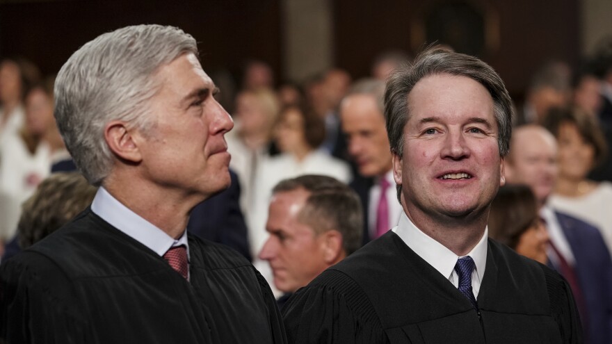 The two newest members of the Supreme Court, Associate Justices Neil Gorsuch, left, and Brett Kavanaugh watch as President Trump arrives to give his State of the Union address in February. Gorsuch and Kavanaugh clerked together for former Justice Anthony Kennedy, whose seat Kavanaugh now fills.