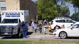 Students evacuate Kemper Elementary School on Wednesday after a shooting at a residence adjacent to the school.