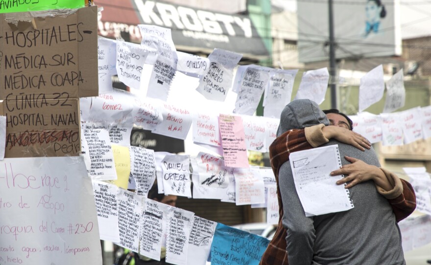 Lists of names crowd a wall in Mexico City, detailing who has been saved and who remained missing Wednesday.