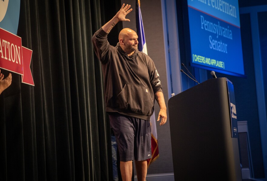 Pennsylvania Sen. John Fetterman walks onto stage in his trademark Carhartt hoodie and basketball shorts Saturday night at Prairie Meadows Casino in Altoona, Iowa. Fetterman was the featured speaker at the Iowa Democratic Party's Liberty and Justice Celebration on Nov. 4.