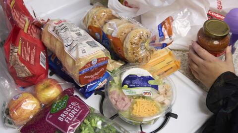 FILE - Groceries are displayed on a counter in Bellflower, Calif.