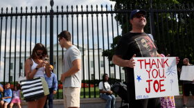 Glenn Boyce and his family show support for President Joe Biden after the president announced his withdrawal from the 2024 race outside the White House in Washington, DC.