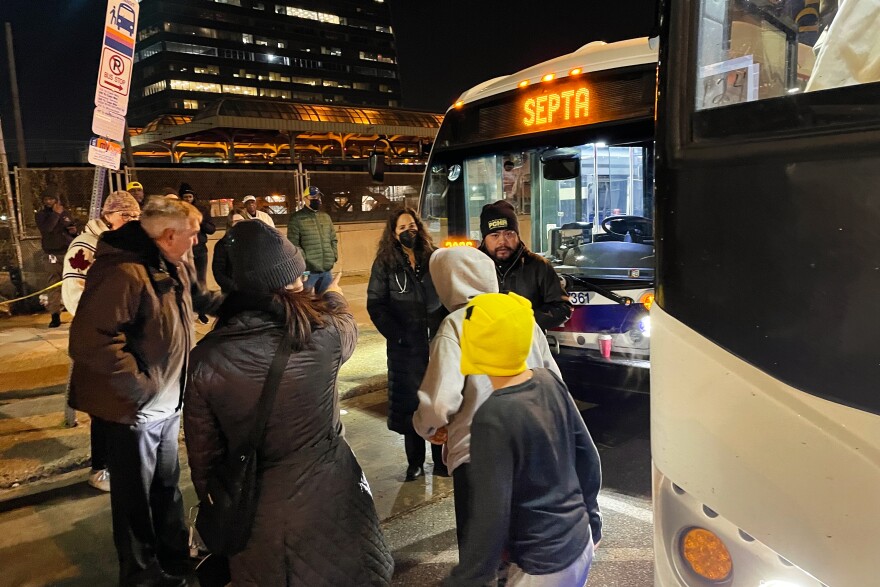 Passengers disembarking from a bus sent to Philadelphia by the state of Texas on December 5, 2022.