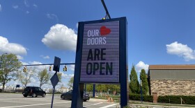 A sign at Easton Town Center in Columbus, advertising that stores, bars and restaurants are open following coronavirus closures.