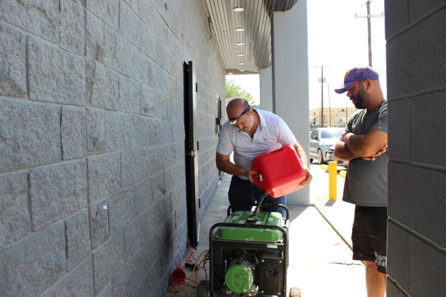 Kareem Abdel Aziz, owner of Westside restaurant Las Delicias Tacos #1, fuels a generator to refrigerate supplies at his restaurant