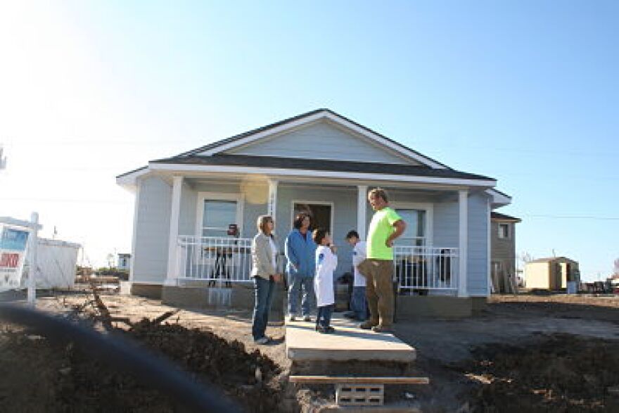Carry Cook, her boys and volunteers outside her new house.