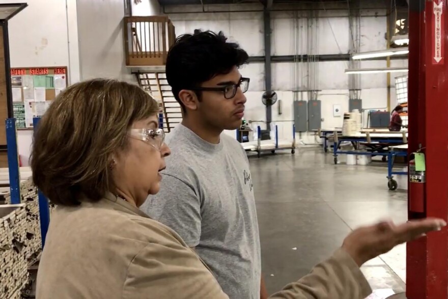 Chris Camacho, a youth apprentice in a similar program in Elkhart County, learns about the operations of the factory on his first day.