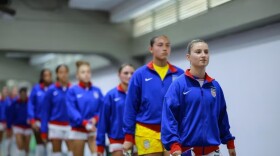 Kansas City Current midfielder Ally Sentnor, at front, walks through a tunnel with her U.S. Women's National Team teammates.