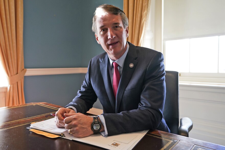 FILE - Virginia Gov. Glenn Youngkin works in the old Governor's office at the Capitol Wednesday March 2, 2022, in Richmond, Va