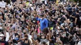 People raise their fists during a protest over the death of George Floyd, Saturday, June 6, 2020, in Miami. Protests continue over the death of Floyd, a black man who died while in police custody in Minneapolis. (AP Photo/Lynne Sladky)