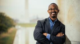 Joshua Johnson, smiling with arms crossed