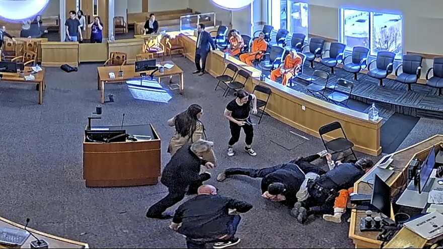 In this still image from video provided by the Second Judicial District Court multiple people brawl inside of a court room on, Friday, Jan. 31, 2025, in Albuquerque, N.M. (Second Judicial District Court/Bernalillo/TMX via AP)