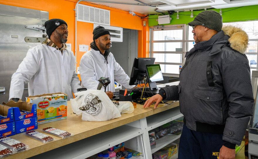 Customer Will Morgan speaks with Chris Harrison and Darwin Harris at Prime Cuts.