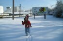 People running through a snow covered field.