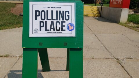 vote here and polling place signs line a street in Ann Arbor, Michigan