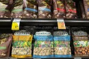 Packages of macadamia nuts are displayed on store shelves on Friday, April 26, 2024, in Honolulu. For decades, tourists to Hawaiʻi have brought home gift boxes of the islands' famous chocolate-covered macadamia nuts for friends and family. (AP Photo/Audrey McAvoy)