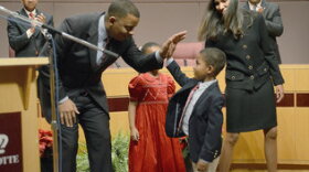 After his swearing in, Mayor Anthony Foxx high-fives son Zachary as daughter Hillary and his wife, Samara, stand by. Foxx also