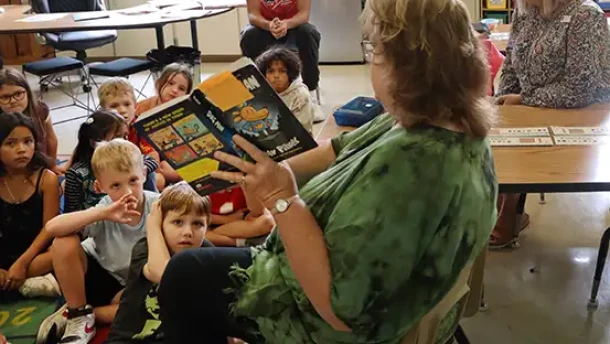 Springfield Public School students listen to the reading of a book.