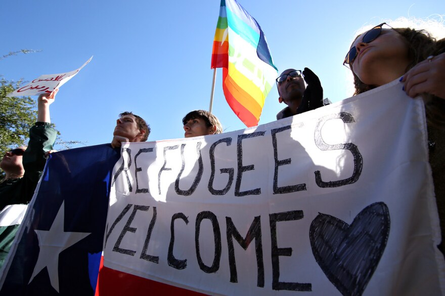 Protesters stand outside the Governor's Mansion at a rally in support of refugee resettlement services in November 2015.