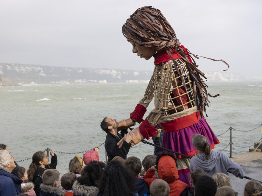 Actor Jude Law walks with Little Amal on Folkestone Pier in Folkestone, UK, on Oct. 19, 2021.