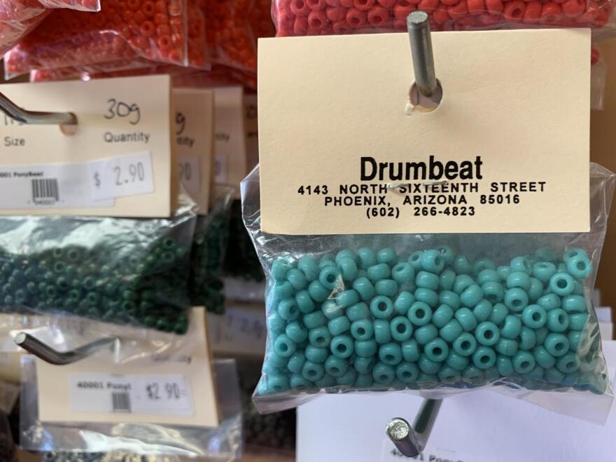 An entire wall display of assorted, markdown glass beads at Drumbeat Indian Arts. 