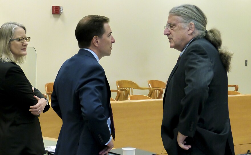 Family attorney Chris Mattei, listens to Alex Jones' attorney Norm Pattis, right, after Pattis decided not to put Jones back on the stand during the Alex Jones Sandy Hook defamation damages trial at Connecticut Superior Court in Waterbury, Conn. Friday, Sept. 23, 2022. At left is family attorney Alinor Sterling.