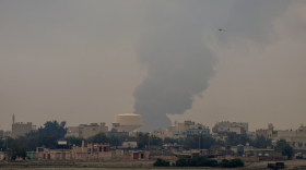 A plume of smoke rises after a reported Iranian strike on fuel tanks in Muharraq, Bahrain, on March 12.