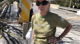 Sharon Brace has been living on Captiva Island for 22 years. She lives in an area surrounded by vacation homes. As a year-round resident of the island, she found herself isolated as Hurricane Ian cut off communications and tore through Captiva. She stands at Port Sanibel Marina after a 50-minute rescue boat ride with no plan and no place to stay.