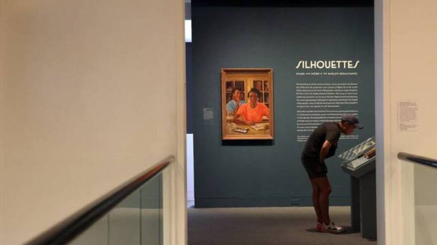 A guest stop to read parts of the “FIRE!” magazine at entrance of the Silhouette exhibition inside The Wolfsonian - FIU on Wednesday, May 22, 2024, in Miami Beach, Florida.