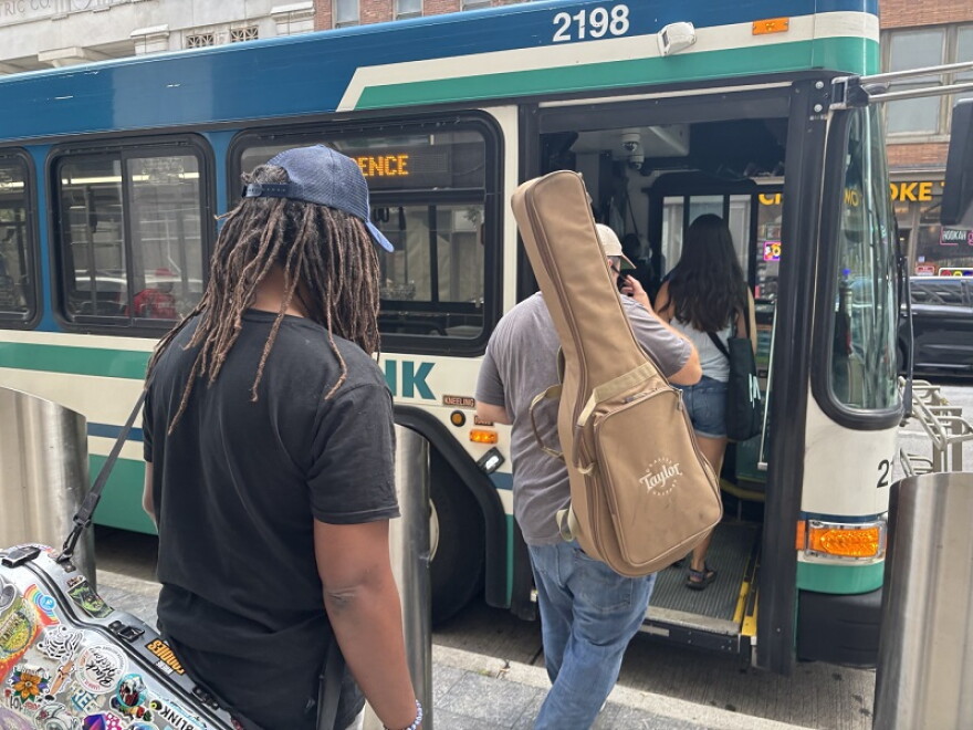 Preston Charles the Third and Nick Rose board the TANK bus. They are ready to make a difference on Ride with an Artist Day.