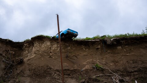 A car on the edge of a cliff over the Wood River