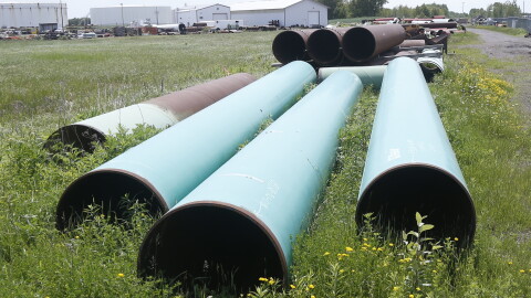 FILE - Pipeline used to carry crude oil sits at the Superior, Wis., terminal of Enbridge Energy, June 29, 2018.