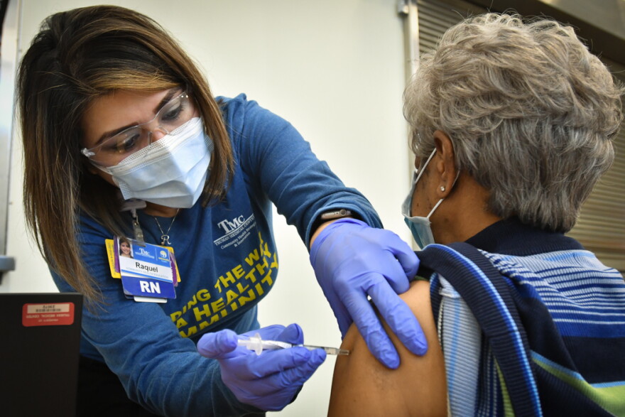 Truman Medical Centers RN Raquel Garcia administers a COVID-19 vaccination on Jan. 26 at Morning Star Missionary Baptist Church.