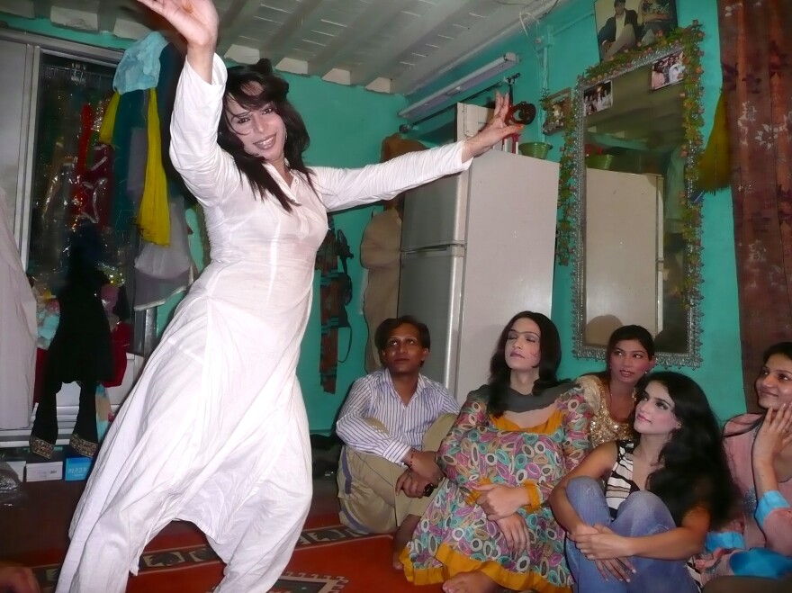 Sameeha, a 22-year-old transgender wedding performer, dances as friends look on during a rehearsal at a friend's home in Rawalpindi.
