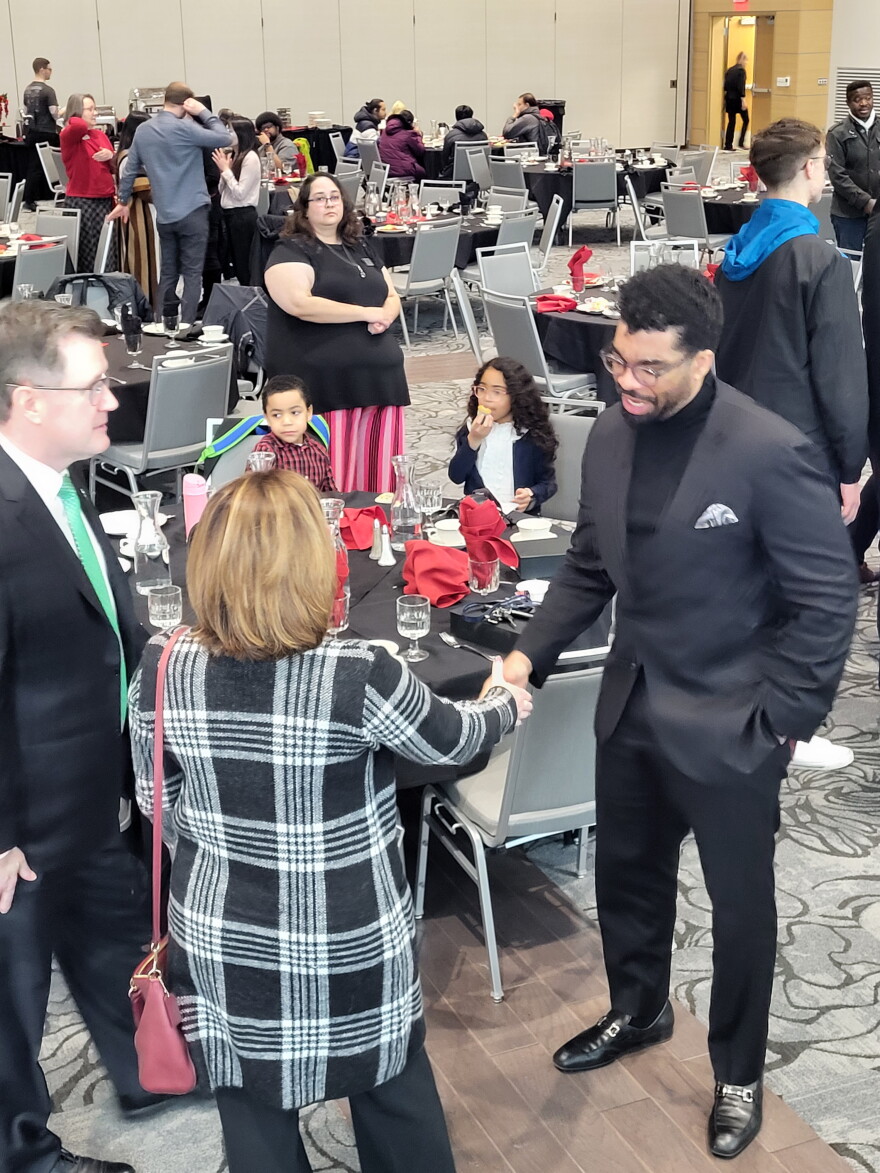 UND President Andrew Armacost and Prof. David Wall Rice talk with audience members after Monday's presentation.