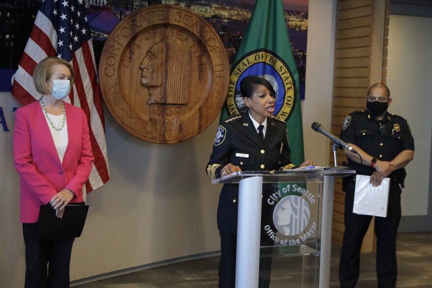 Seattle Police Chief Carmen Best, center, speaks as Seattle Mayor Jenny Durkan, left, and Deputy Police Chief Adrian Diaz, right, look on during a news conference, Tuesday, Aug. 11, 2020, in Seattle.