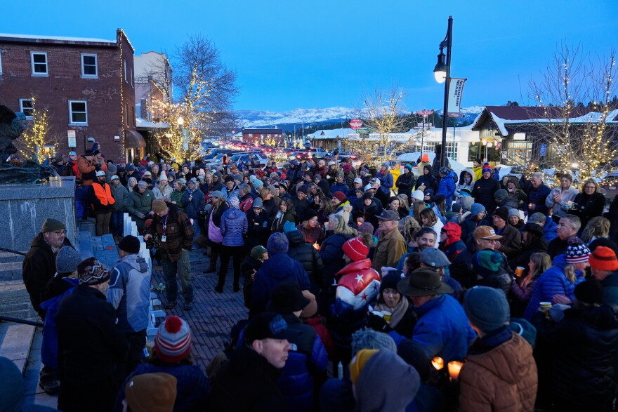 A crowd of people standing together in downtown Truckee for a vigil.