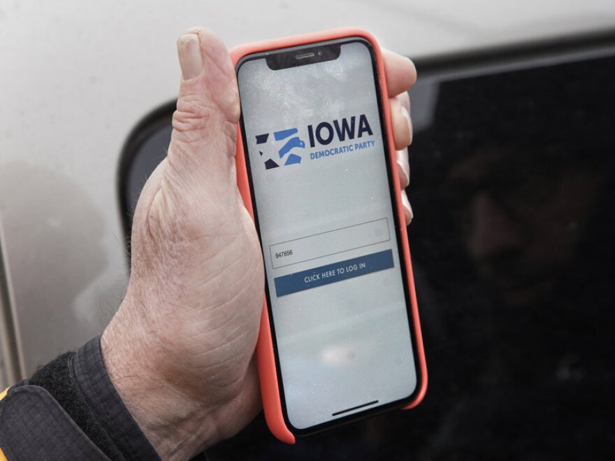 Precinct captain Carl Voss of Des Moines displays the Iowa Democratic Party caucus reporting app on his phone outside the Iowa Democratic Party headquarters on Tuesday.