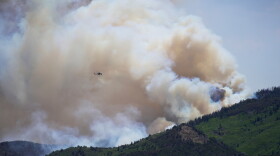 A helicopter flies near the Cottonwood Fire in Beaver, Utah, Tuesday, June 30, 2026. (AP Photo/Ty ONeil)