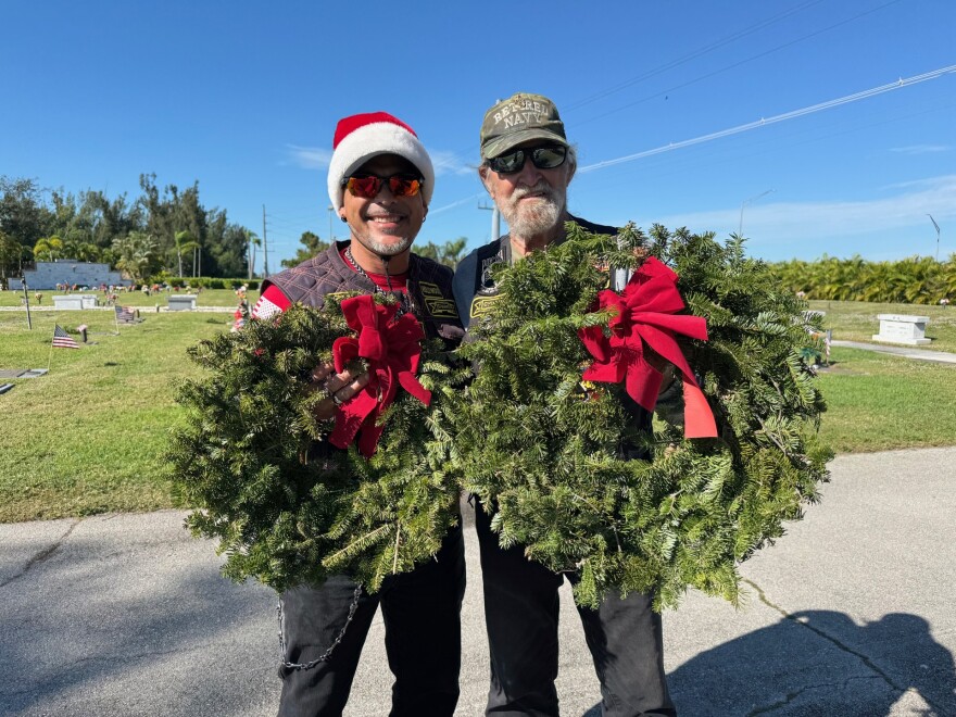 Chris Garrick, left, and Fed Monson, prepare to place wreaths at Coral Ridge Cemetery in Cape Coral. The two men were volunteering with the Combat Veterans Motorcycle Association for the Wreaths Across America.