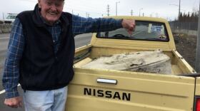 93-year-old Glenn Hackney, giving the thumbs down to a mattress he hauled off the side of the road in Fairbanks on April 30th, 2018. He starts picking up roadside trash as soon as the snow melts each year. (Ravenna Koenig/ Alaska’s Energy Desk)