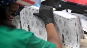 A Clark County election worker scans mail-in ballots on Nov. 7 in North Las Vegas, Nevada. CREDIT: Ethan Miller/Getty Images