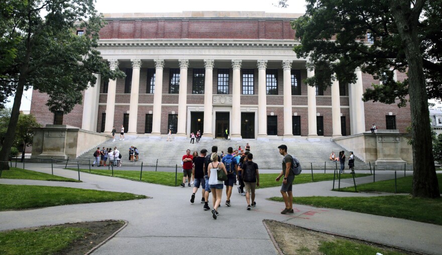 Students walk near the Widener Library at Harvard University in Cambridge, Massachusetts, Aug. 13, 2019. 