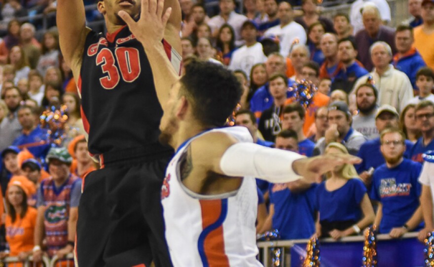 Georgia's J.J. Frazier (30) pulls up for a jump shot over Florida's Chris Chiozza (11) in the first half. Frazier was one of three Bulldogs who finished in double figures. (Greenberry Taylor/WUFT News)