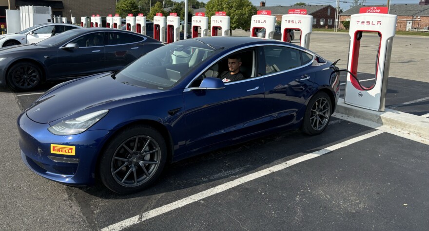 Fernando Martinez charges his electric vehicle at a Tesla Supercharger station. Indianapolis is among the worst in the country for energy efficiency, especially when it comes to the transportation sector.